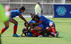 Teammates embrace Florencina Kalifa as she celebrates her goal against Koloale FC