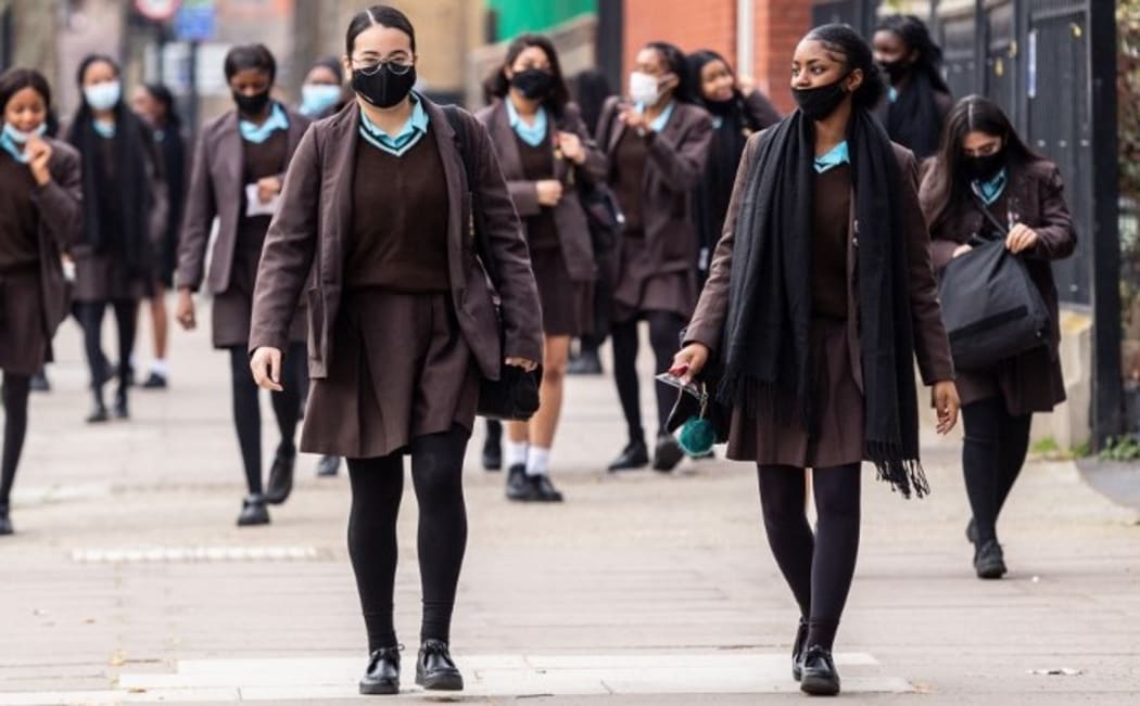 Students of Notre Dame secondary school walk out from the building after the first day at school  in southern London as schools in England reopen on March 8, 2021.