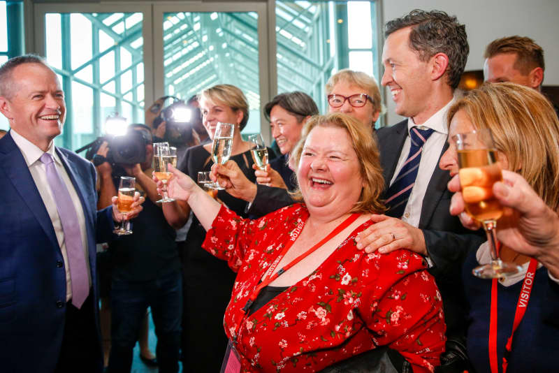 Same Sex Marriage Ambassador Magda Szubanski celebrates with Labor opposition leader Bill Shorten (L) and members of the Labor Party after the Australian Parliament passed the same-sex marriage bill in Canberra on December 7, 2017. Gay couples will be able to legally marry in Australia after a same-sex marriage bill sailed through parliament on December 7, ending decades of political wrangling. (Photo by SEAN DAVEY / AFP)