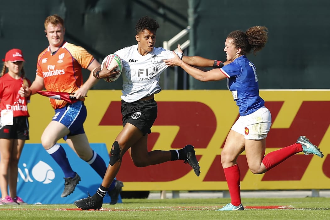 Fiji's Naina Baleca fends off a France defender in Dubai.