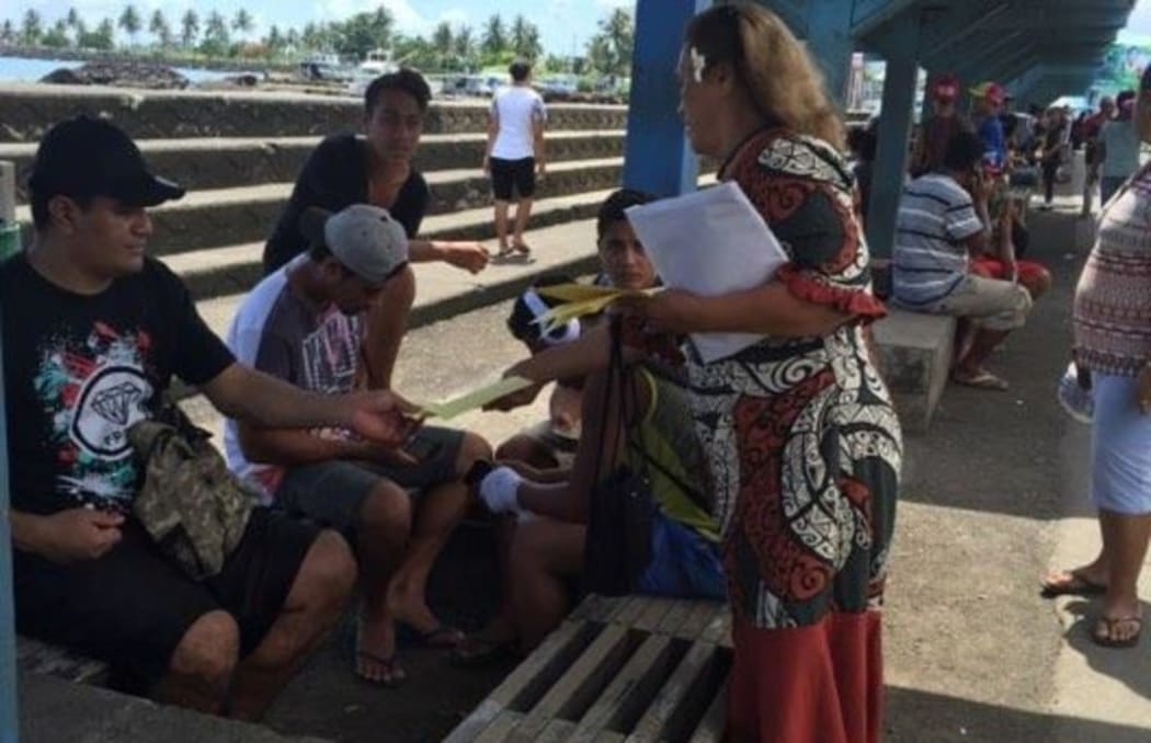 Samoa Solidarity International Group's Ruta Lealaitafea Westin handing out pamphlets to people at the Makeki in Apia. December 2017.
