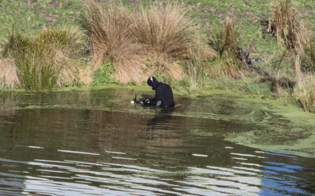 Police dive squad search a pond looking for missing boy Khyzah.