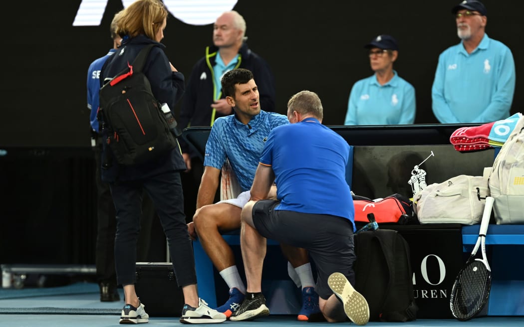 Novak Djokovic of Serbia gets medical attention during the 2023 Australian Open.