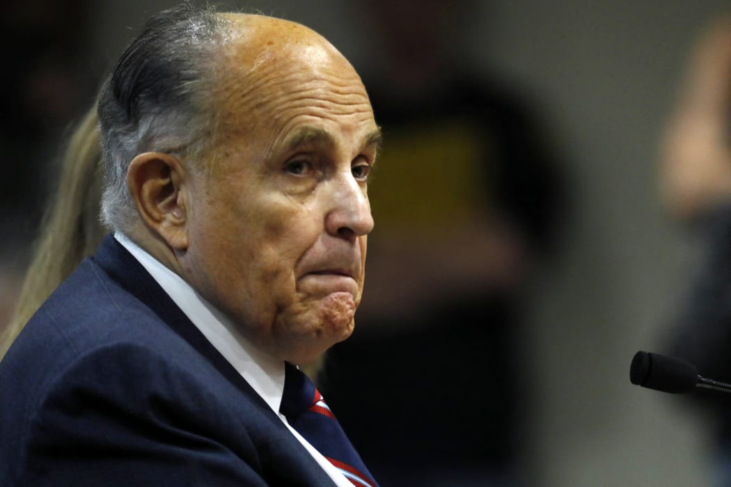 (FILES) In this file photo Rudy Giuliani, former personal lawyer of US President Donald Trump, looks on during an appearance before the Michigan House Oversight Committee in Lansing, Michigan on December 2, 2020.