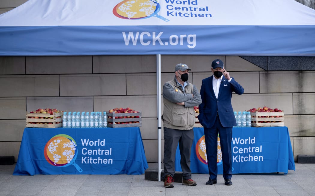 US President Joe Biden (R) stands with Spanish chef Jose Andres, founder of nonprofit organisation World Food Kitchen (WCK) after meeting refugees of Russia's war with Ukraine at PGE Narodowy Stadium in Warsaw, Poland on March 26, 2022. (Photo by Brendan Smialowski / AFP)