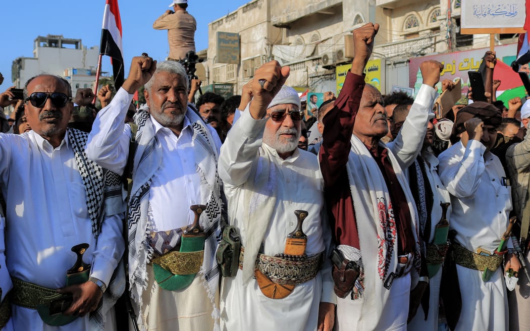 People take part in a protest in the streets of the Yemeni Red Sea city of Hudeida, to condemn the overnight US and British forces strikes on Huthi rebel-held cities, on January 12, 2024, amid ongoing battles between Israel and the militant Hamas group in Gaza. US and British forces struck rebel-held Yemen early on January 12, after weeks of disruptive attacks on Red Sea shipping by the Iran-backed Huthis who say they act in solidarity with Gaza. The pre-dawn air strikes add to escalating fears of wider conflict in the region, where violence involving Tehran-aligned groups in Yemen as well as Lebanon, Iraq and Syria has surged since the Israel-Hamas was began in early October. (Photo by AFP)