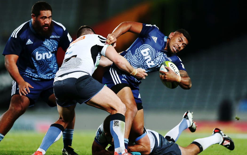 The Blues' Charles Piutau tries to escape tacklers