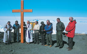 Mt Erebus disaster: plane crash 28 November 1979: Air New Zealand Flight TE901: DC-10. Dedication of the Erebus memorial cross 2 December 1979: left to right:US Navy Chaplain, Garth Varcoe, Bob Dunnachie (obscured); Father Creagh, Mike Prebble, unknown (probably Anne Martindell, US Ambassador), Bob Thomson, Captain Westbrook, unknown Copyright Owner Antarctica New Zealand