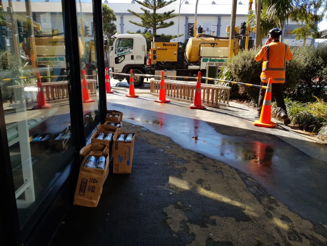 Workers at the site of the burst water main near the TSB Arena, Wellington.