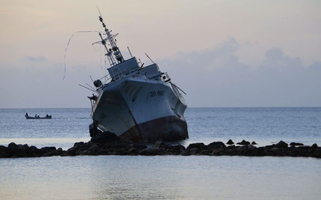 A ship rests on rocks after it ran aground during storms brought on by Super Typhoon Maysak near the coastal village of Neauo on the southern coast of the island of Weno in the Micronesian state of Chuuk. Federated States of Micronesia