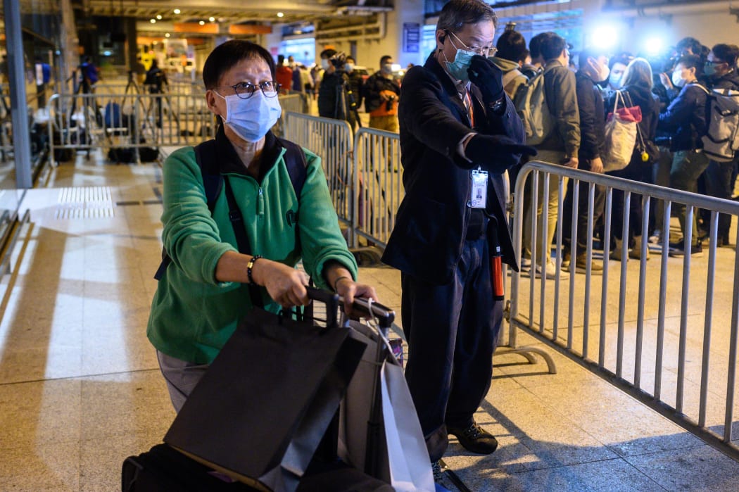 Passengers leave the World Dream cruise ship in Hong Kong on 9 February.
