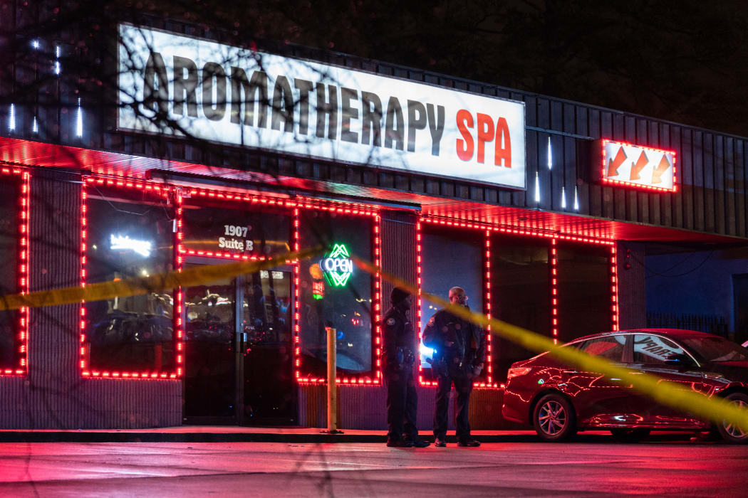 Law enforcement personnel are seen outside a massage parlor where a person was shot and killed on March 16, 2021, in Atlanta, Georgia.