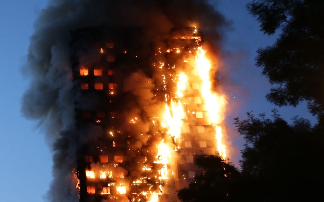 (FILES) Fire engulfs Grenfell Tower, a residential tower block on June 14, 2017 in west London. The inquiry into the Grenfell Tower disaster that killed 72 people in Britain's worst residential fire since World War II will on September 4, 2024 publish its long-awaited final report. The fire in the early hours of June 14, 2017 spread rapidly through the 24-storey block in west London due to highly combustible cladding fixed to the exterior. (Photo by Daniel LEAL / AFP)