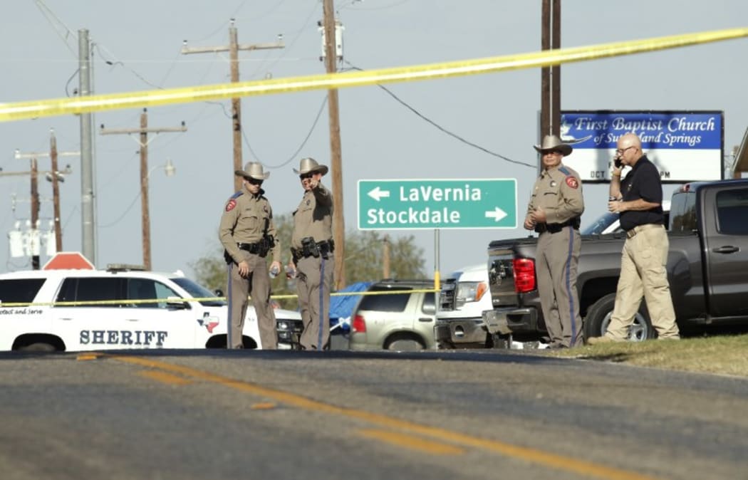 Law enforcement officials gather near First Baptist Church following a deadly mass shooting.