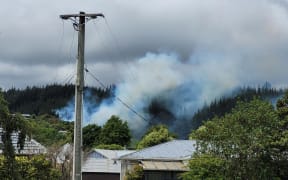 A helicopter is supporting firefighters battling a bush fire in Upper Hutt on 4 December 2024.