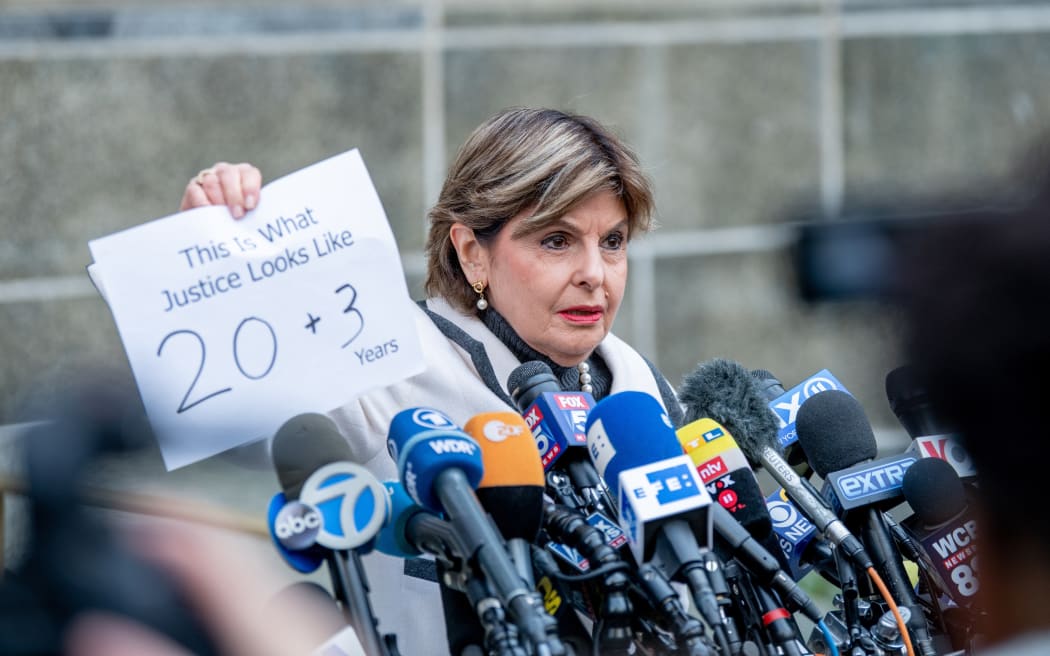 Attorney Gloria Allred, who represented three of the women who testified in the trial, speaks to reporters outside the outside the Manhattan court, holding a sign showing the sentence given to Harvey Weinstein.