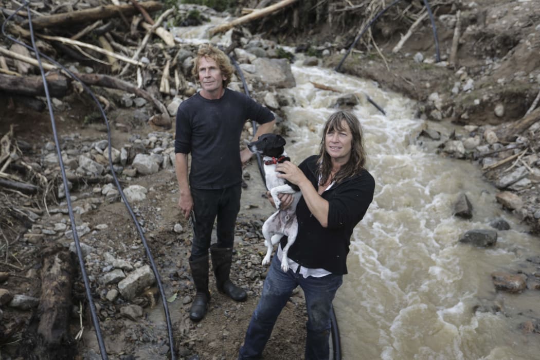 Barrytown was hit hard in former Tropical Cyclone Gita. Rita Bennett and her neighbour Mark Clisby repair a water pipe after a massive slip ripped through the property.