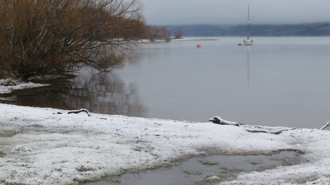 Snow settles on the edge of Lake Wakatipu in Glenorchy.