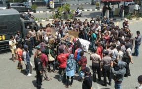 Police make their presence felt at small protest in Yogyakarta to mark the anniversary of the New York Agreement about West Papua, 15 August 2017.