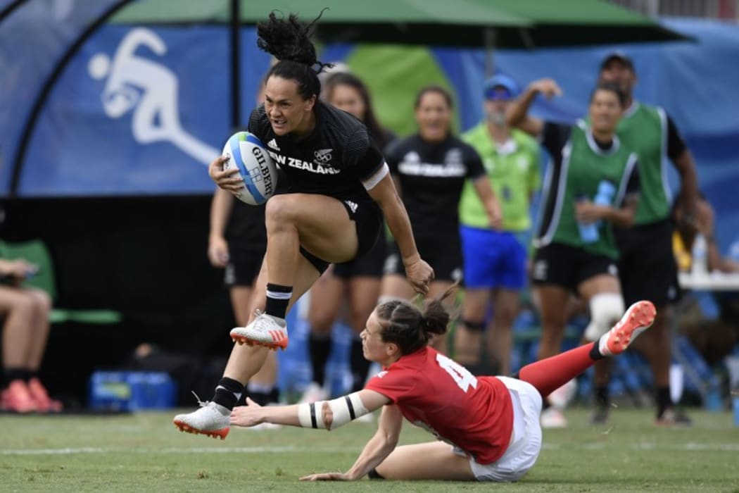 Portia Woodman runs past Britain's Emily Scarratt in the women’s rugby sevens semi-final.