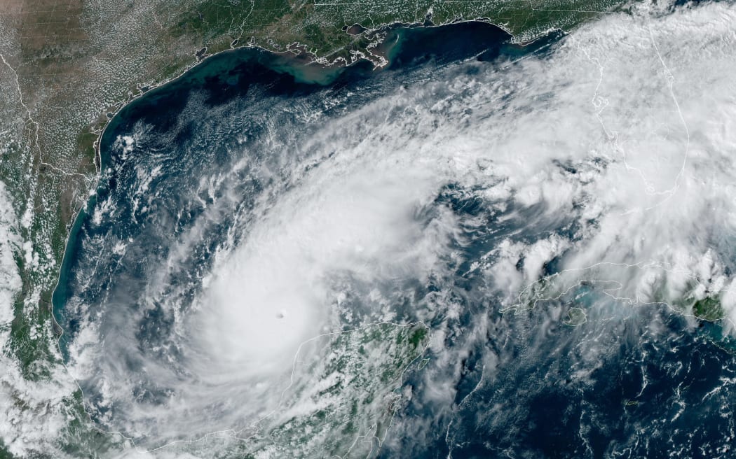 This handout satellite image courtesy of the National Oceanic and Atmospheric Administration (NOAA) and the Regional and Mesoscale Meteorology Branch (RAMMB) shows hurricane Milton churning over the Gulf of Mexico on October 7, 2024. - Hurricane Milton exploded in strength Monday to become a potentially catastrophic Category 5 storm bound for Florida, threatening the US state with a second ferocious hurricane in as many weeks. (Photo by HANDOUT / NOAA / AFP) / RESTRICTED TO EDITORIAL USE - MANDATORY CREDIT 