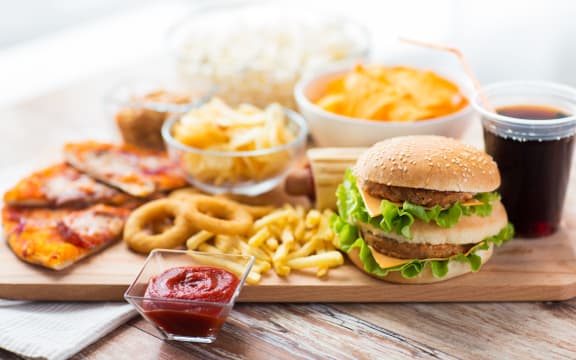 Close up of fast food snacks and drink on table.