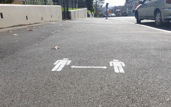 2 metre distance signs on Auckland footpaths on day one of alert level 3 on 28 April.