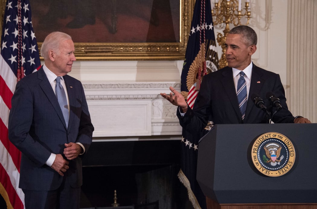 Former US Vice President Joe Biden wipes away tears as he walks past former president Barack Obama after he was awarded the Presidential Medal of Freedom during a tribute to Biden at the White House in Washington, DC on January 12, 2017.