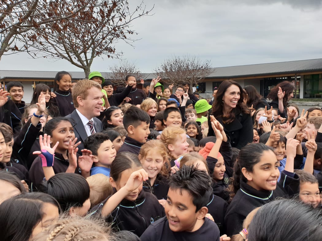 Education Minister Chris Hipkins and PM Jacinda Ardern with school students following today's announcement.