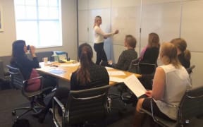 Georgia Woodward gives te reo lessons to her colleagues.