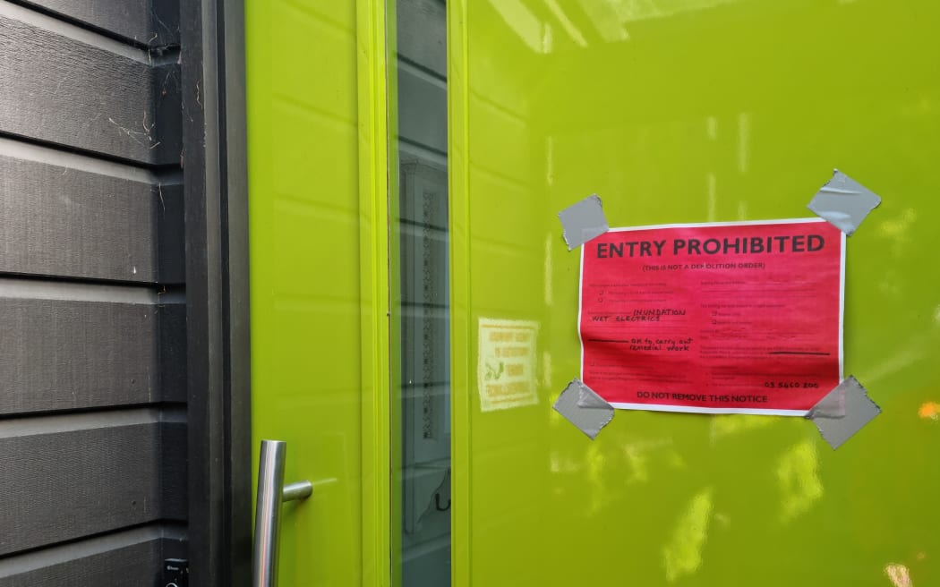 The red sticker on Julie Ambrose and Geoff Moffett's home.
