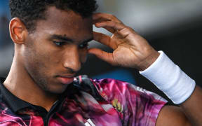 Canada's Felix Auger-Aliassime reacts as he plays against Czech Republic's Jiri Lehecka during their men's singles match on day seven of the Australian Open tennis tournament in Melbourne on January 22, 2023. (Photo by Paul CROCK / AFP) / -- IMAGE RESTRICTED TO EDITORIAL USE - STRICTLY NO COMMERCIAL USE --