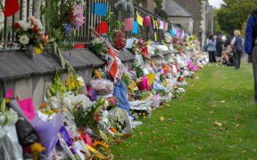 Christchurch Botanic Gardens wall with hundreds of flowers laid in memory of those lost in the mosques shooting