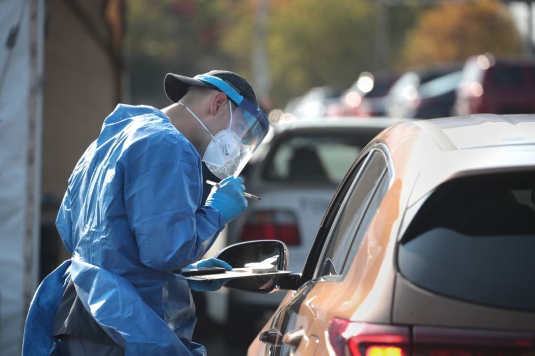 MILWAUKEE, WISCONSIN - OCTOBER 09: Members of the Wisconsin National Guard test residents for the coronavirus COVID-19 at a temporary test facility set up in the parking lot of the UMOS corporate headquarters on October 09, 2020 in Milwaukee, Wisconsin.