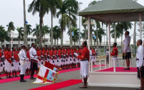 Fiji President Jioje Konrote salutes military as they play the national anthem.
