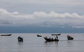 SEBAGORO, UGANDA - APRIL 04: Children row a boat on Lake Albert by the UNHCR landing site for refugee arrivals from the Democratic Republic of Congo on April 4, 2018 in Sebagoro, Uganda.