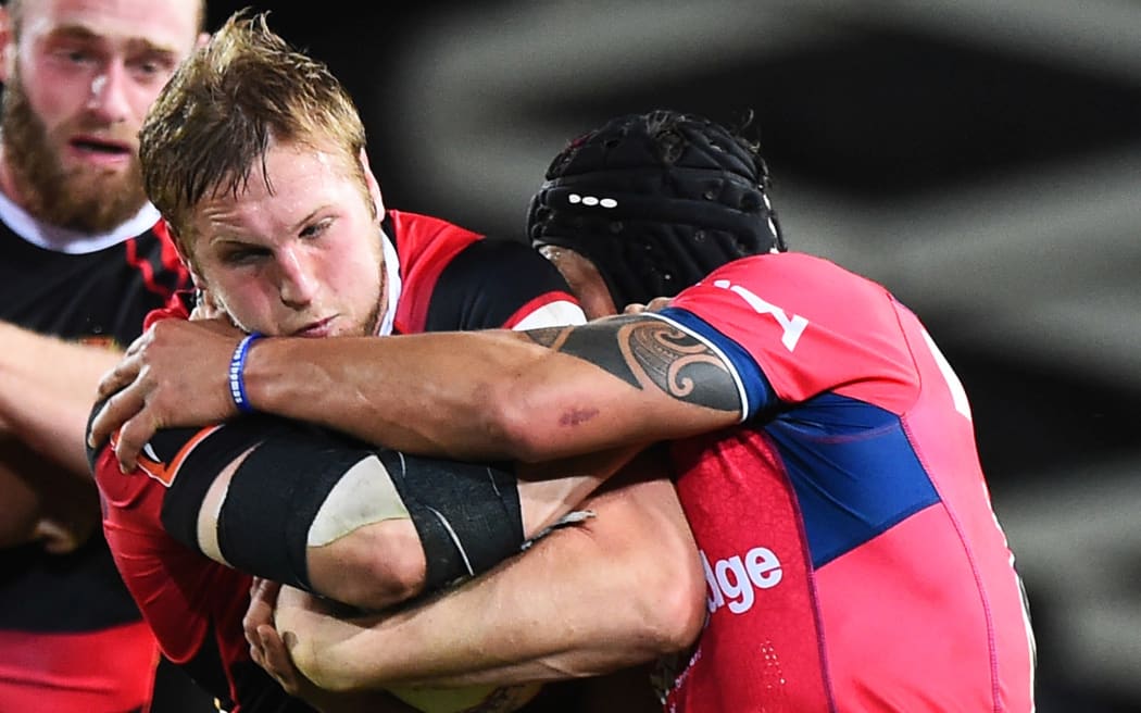 Canterbury's Mitchell Dunshea is tackled by a Tasman player.