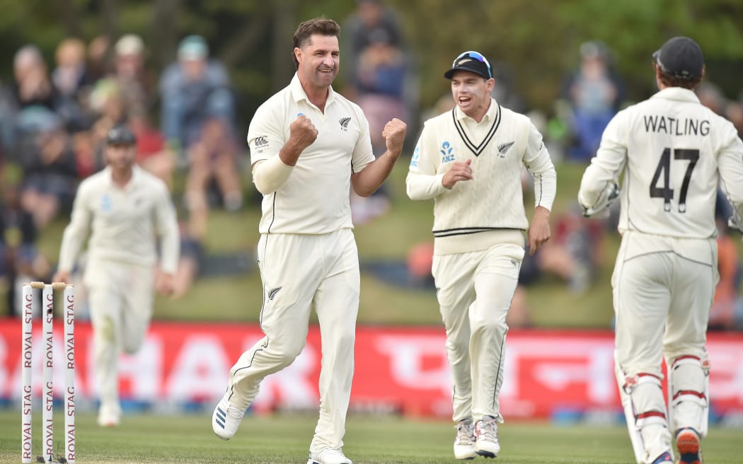 New Zealand bowler Colin de Grandhomme (centre left) celebrates with teammates after taking the wicket of India's captain Virat Kohli (not pictured) on day two of the second Test cricket match between New Zealand and India at Hagley Oval in Christchurch on March 1, 2020.