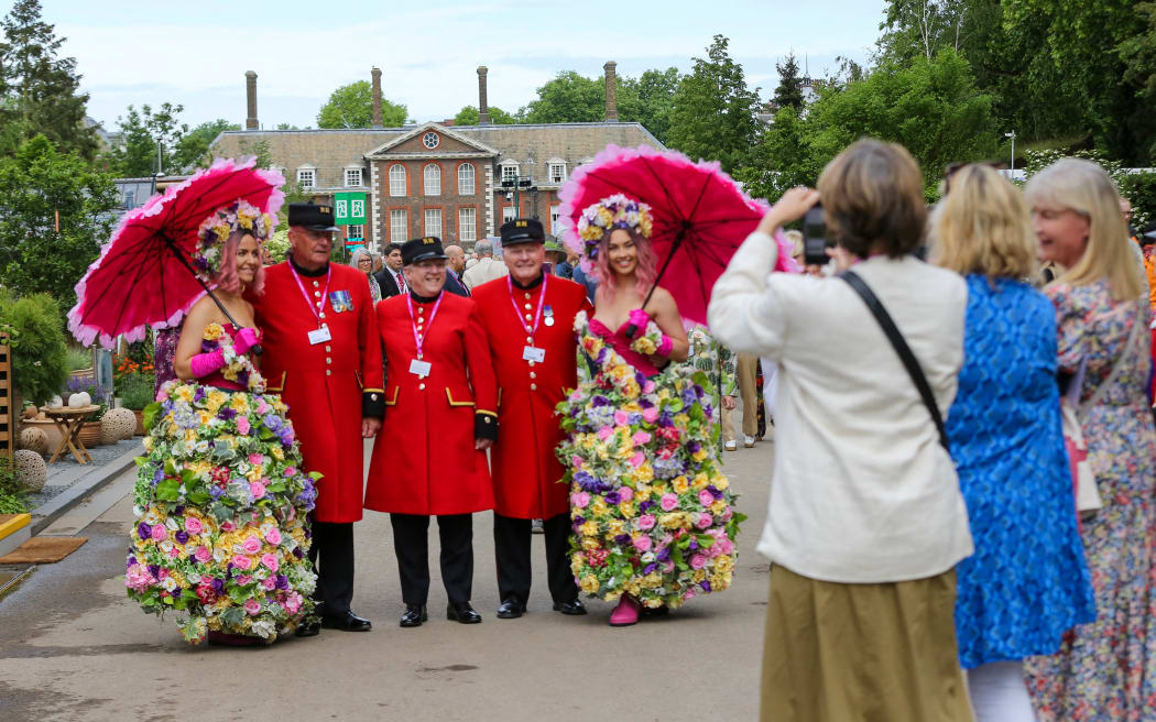 LONDON, UNITED KINGDOM - MAY 23: Women take photos of models wearing floral outfits on the press preview day of the RHS Chelsea Flower Show held by the Royal Horticultural Society at Royal Hospital Chelsea in London, United Kingdom on May 23, 2022. This year's show feature special displays to mark the Queen's platinum jubilee. Dinendra Haria / Anadolu Agency (Photo by Dinendra Haria / ANADOLU AGENCY / Anadolu Agency via AFP)