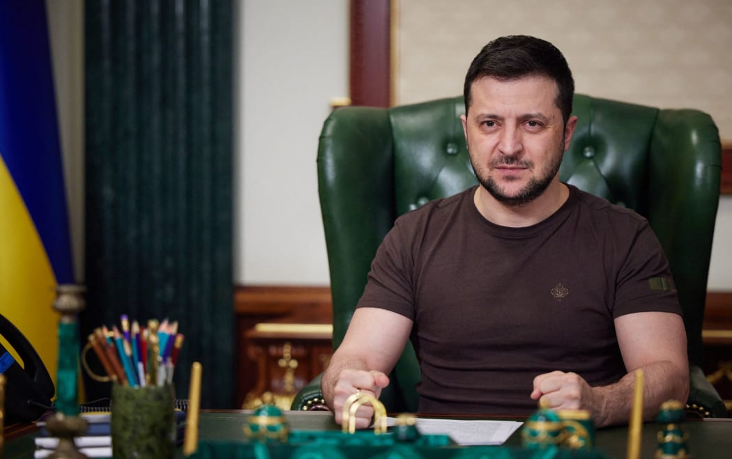 In this handout picture taken and released by the Ukrainian Presidency Press Office early on March 14, 2022, Ukrainian President Volodymyr Zelensky delivers a video address in Kyiv. -