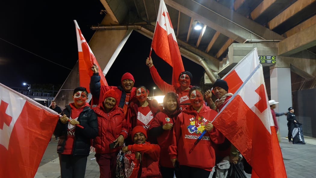 Tonga fans leave the stadium in good spirits.