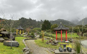 A view of the Ross Chinese Memorial Garden with the former mine lake causing issues on the garden edge.