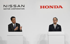 (L to R) Nissan President Makoto Uchida, and Honda President Toshihiro Mibe, attend a joint press conference in Tokyo on Dec. 23, 2024. Honda and Nissan announced that they have begun discussions to merge their businesses, with Mitsubishi Motors also considering joining the two companies.( The Yomiuri Shimbun ) (Photo by Taketo Oishi / Yomiuri / The Yomiuri Shimbun via AFP)
