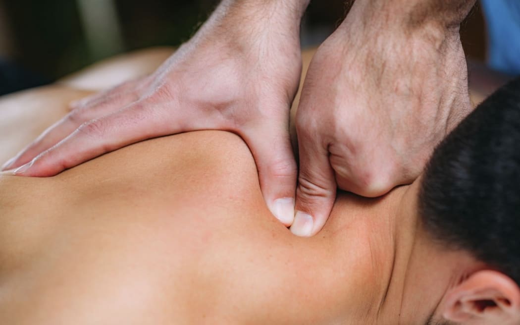 Physiotherapist massaging patient's shoulder. (Photo by MICROGEN IMAGES/SCIENCE PHOTO LI / SMD / Science Photo Library via AFP)