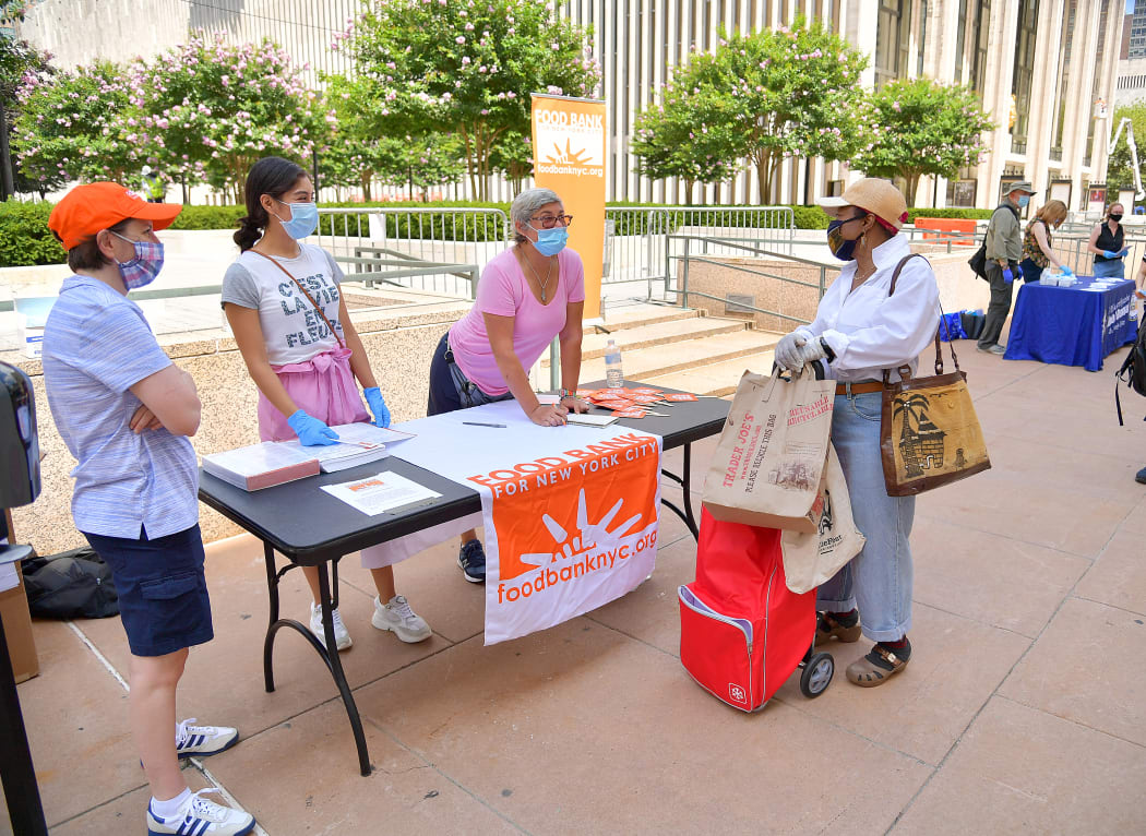 New Yorkers in need receive free produce, dry goods, and meat at a Food Bank For New York City distribution event at Lincoln Center on 29 July, 2020, in New York City