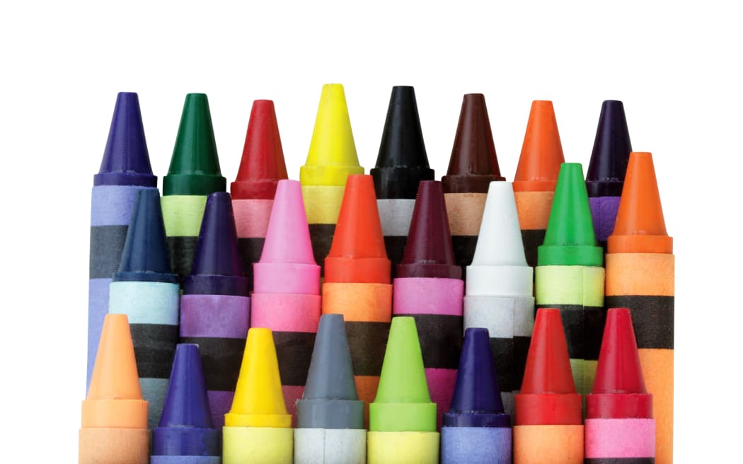 Three rows of wax crayons in a box