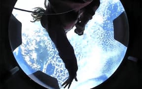 This September 16, 2021, image courtesy of Inspiration4 shows the Inspiration4 crew member Hayley Arceneaux looking out of an observation window while in orbit.