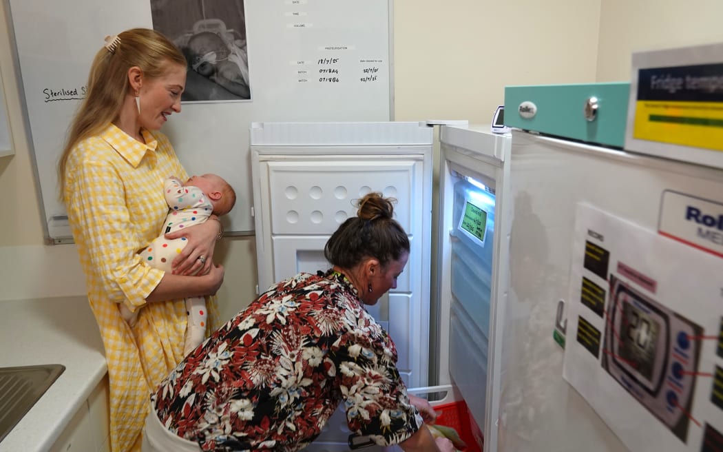 The bank’s first donor, Whangārei mum Ashlee Robinson, watches as her milk is stored in the milk bank freezer until needed.
