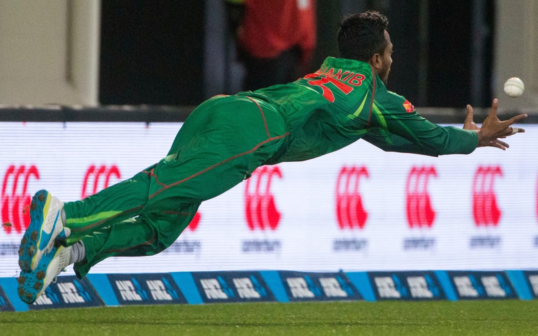 Shakib Al Hasan takes a diving catch to dismiss Neil Broom.