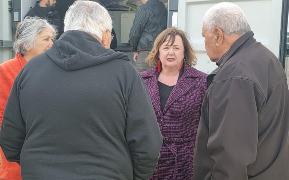 Megan Woods speaking with kaumātua who live in the four flats.